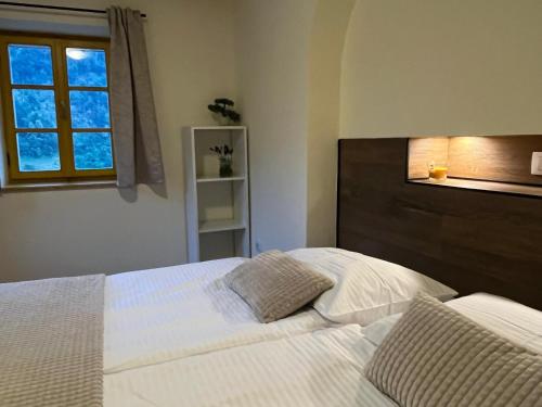 a bedroom with a white bed and a window at Apartment Abinkar in Tolmin