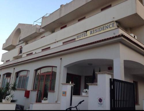 a building with a sign that reads hotel residence at Hotel Lungomare Brancaleone in Brancaleone Marina