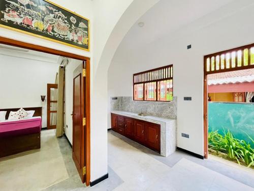 a bathroom with a sink and a large aquarium at Bentota Upali Villa in Bentota