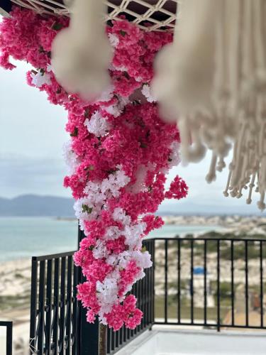 a bunch of pink and white flowers hanging from a ceiling at Dar Al Makam - Luxury Experience in Soliman