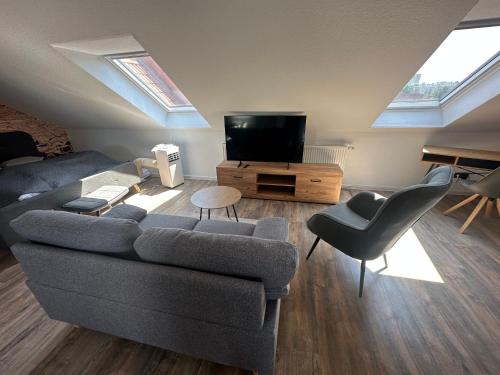 a living room with a couch and a tv at Ferienwohnung Zeitz - Weiße Elster Apartment in Zeitz