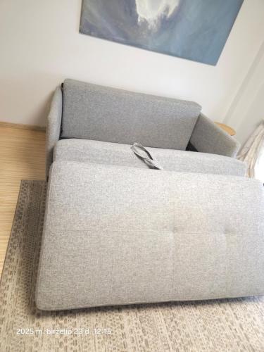a couch sitting on a rug in a living room at Happy Inn Sweet Old Town Studio, Self check in, Parking in Vilnius