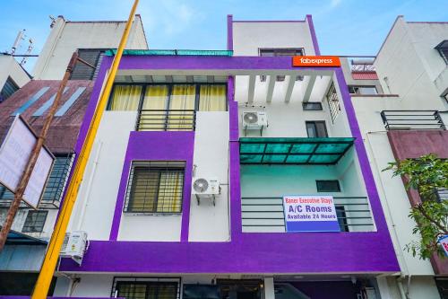 a purple and white building with a sign on it at FabExpress Baner Executive - Balewadi high street in Pune
