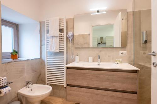 a bathroom with a sink and a toilet and a mirror at Vico degli Orti in Mistretta