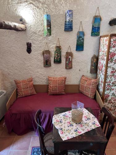 a room with a bed and a table with bags on the wall at La casa di Martina in Castelpizzuto