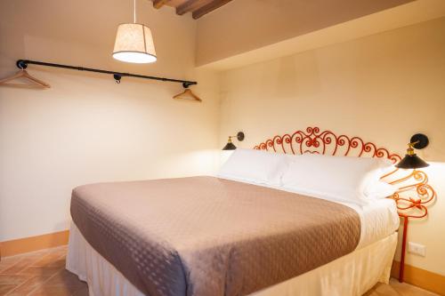 a bedroom with a large bed in a room at Rocca d'Orcia Suites and Villas in Castiglione dʼOrcia