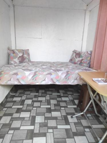 a bed in a room with a table and a desk at Pensiunea agroturistica Casa Sirca in Boghiş