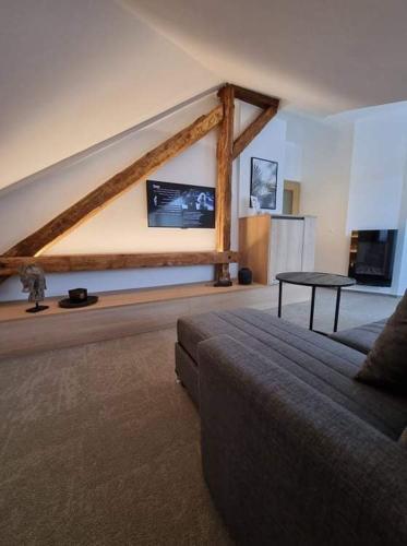 a living room with a couch and a table at Apartmán Na Břehu in Luhačovice