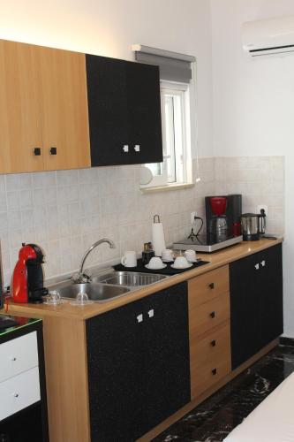 a kitchen with a sink and a counter top at Κatholikis Room in Kremasti