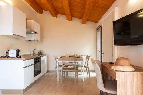 a kitchen and dining room with a table and chairs at Vico degli Orti in Mistretta