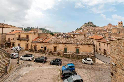 a group of cars parked in front of a city at Vico degli Orti in Mistretta
