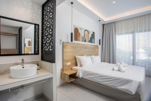 a hotel room with a bed and a sink at Aiora Resort in Pefki Rhodes