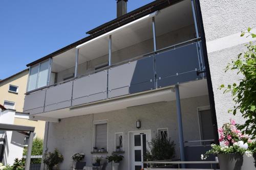 an external view of a building with glass balconies at Bodensee Apartment Gresser in Meckenbeuren