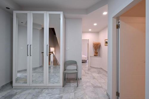 a hallway with a white cabinet and a chair at Villa Blue Horizon in Tiberias