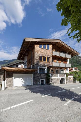 a large brick house with a large garage at Haus Wierer in Mayrhofen