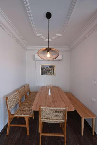 a dining room with a wooden table and chairs at Villa Blue Horizon in Tiberias