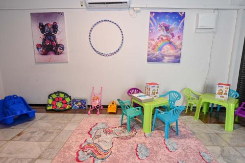a room with colorful tables and chairs in a room at Villa Blue Horizon in Tiberias