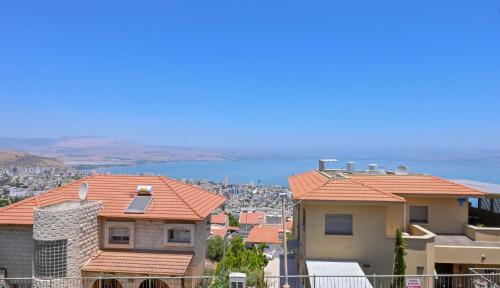 a group of houses with the ocean in the background at Villa Blue Horizon in Tiberias