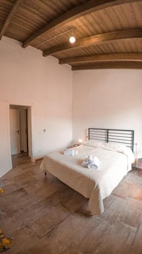 a bedroom with a large bed in a room at Sardinian Gallery Domus in Bosa