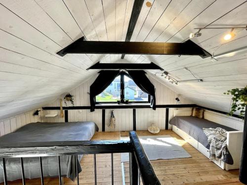 a room with a bed and a window in a tent at Charming 5 bed studio at Getterön in Varberg