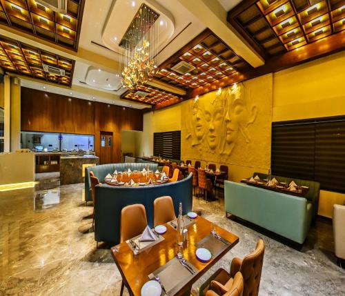 a restaurant with tables and chairs and a bar at Araiya Gir,A Mavintara Resort in Chitrāwal