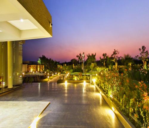 a night view of a building with lights at Araiya Gir,A Mavintara Resort in Chitrāwal