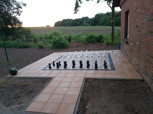 a chess board on a patio with a chess at Ferienwohnung "Grüne Auszeit" in Groß Wokern