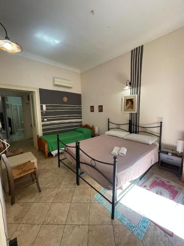 a bedroom with a bed and a couch and a table at Il Tamburello in Floridia