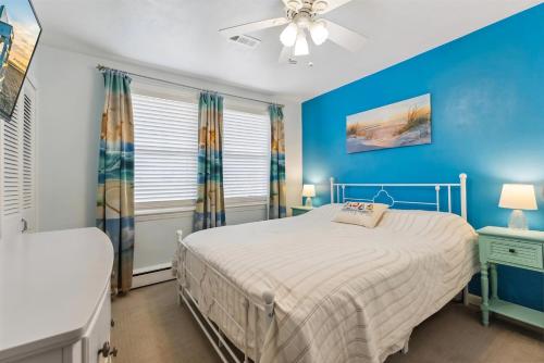 a blue bedroom with a bed and a ceiling fan at 307 E Crocus Rd, Unit B in Wildwood Crest