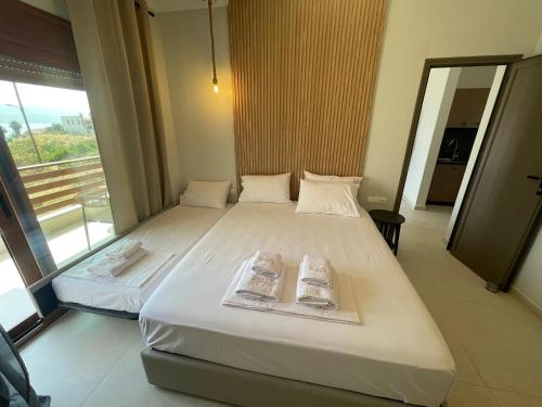 a bedroom with a bed with two towels on it at seaandolive in Ammouliani