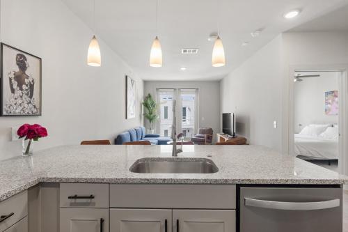 a kitchen with a sink and a living room at Brand New luxury 1 bedroom in Austin