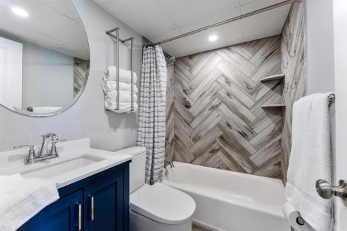 a bathroom with a sink toilet and a mirror at 301 Ocean Ave, Unit 316 - The Harbor Light in North Wildwood