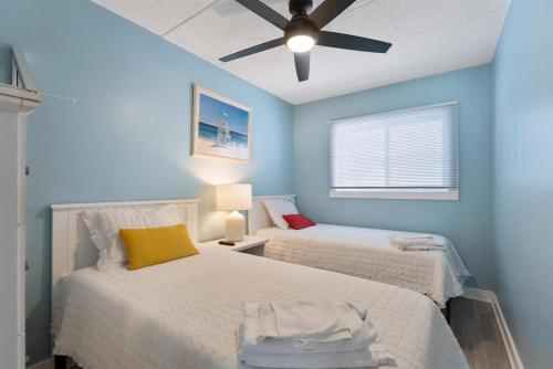 a bedroom with two beds and a ceiling fan at 301 Ocean Ave, Unit 316 - The Harbor Light in North Wildwood