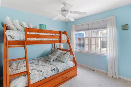 a bedroom with two bunk beds and a ceiling fan at Gorgeous 3 Bedroom Condo with Ocean Views & Garage Parking in Wildwood