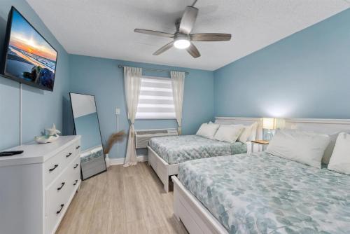 a bedroom with two beds and a ceiling fan at 301 Ocean Ave, Unit 110 - The Harbor Light in North Wildwood