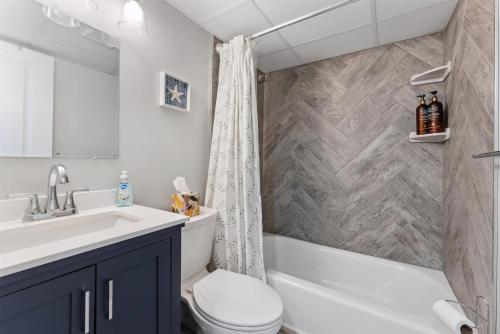 a bathroom with a sink and a toilet and a shower at 301 Ocean Ave, Unit 110 - The Harbor Light in North Wildwood