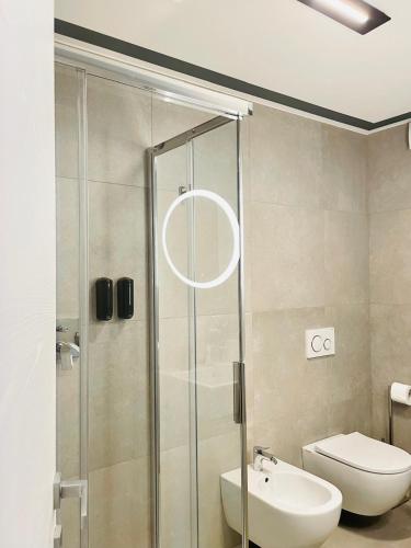 a bathroom with a shower with a toilet and a sink at Maderni Loft in Como