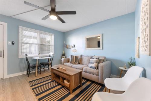 a living room with a couch and a table at 301 Ocean Ave, Unit 109 - The Harbor Light in North Wildwood
