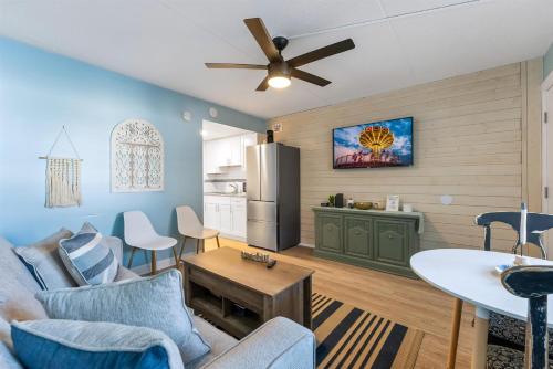 a living room with a couch and a refrigerator at 301 Ocean Ave, Unit 109 - The Harbor Light in North Wildwood