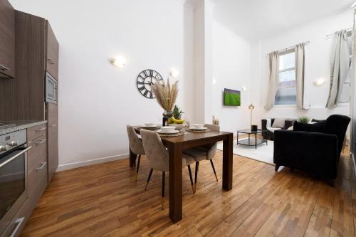 a kitchen and dining room with a table and chairs at Modern 3BR - Flat Sleeps 8 - Walk to Liverpool St in London