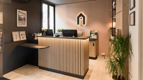an office with a reception desk with aocemetery at Campanile PRIME - Paris 15 Tour Eiffel in Paris