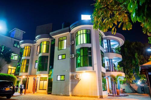 a building at night with people walking in front of it at Green Mountain Hotel in Arusha
