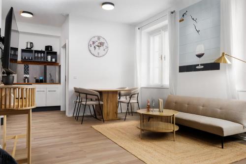 a living room with a couch and a table at Design-Apartments in der Braunauer Altstadt in Braunau am Inn