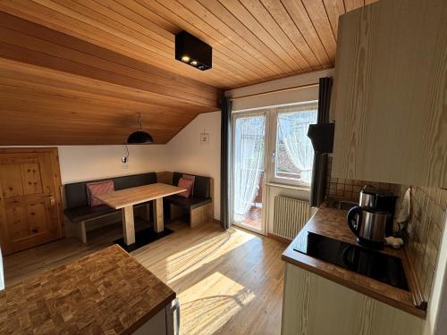 a kitchen with a table in the middle of a room at Residence Linde - Ferienwohnungen & Apartments in Castelrotto