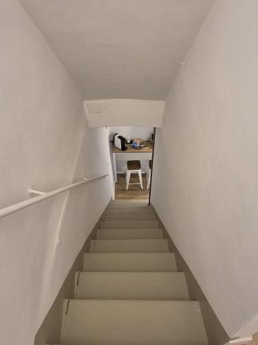 a staircase leading up to a room with a chair at Civico 41 in Pettorano sul Gizio