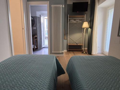 a bedroom with two beds and a room with a closet at Civico 41 in Pettorano sul Gizio