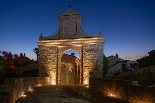 a building with a tower with lights on it at Stadthaus Felix Convivium in Barchi