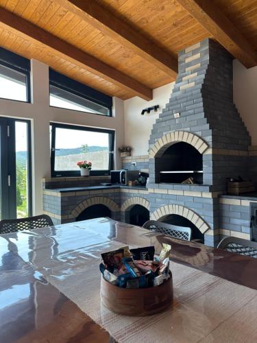 a large living room with a stone fireplace at A Green Nest in Suceava
