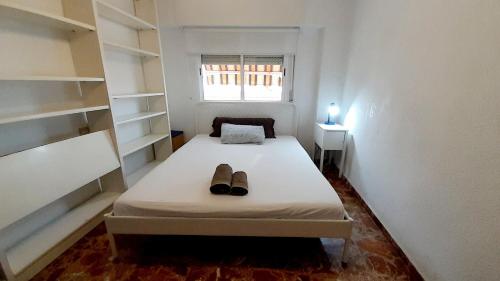 a bedroom with a bed with a pair of shoes on it at Murcia a tus pies, La Alberca in La Alberca
