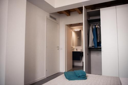 a room with a closet with a blue towel on the floor at Maison Selva - Palazzo Cervi Duplex Superior in Salò